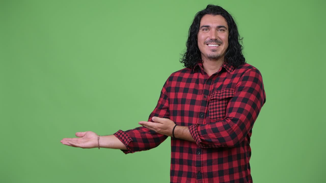 Handsome hipster man showing something