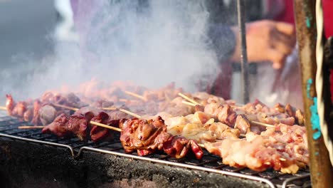 meat grilling on a smoky outdoor barbecue