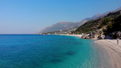 paradise beach with pebbles washed by crystal azure sea water on beautiful coastline of albania