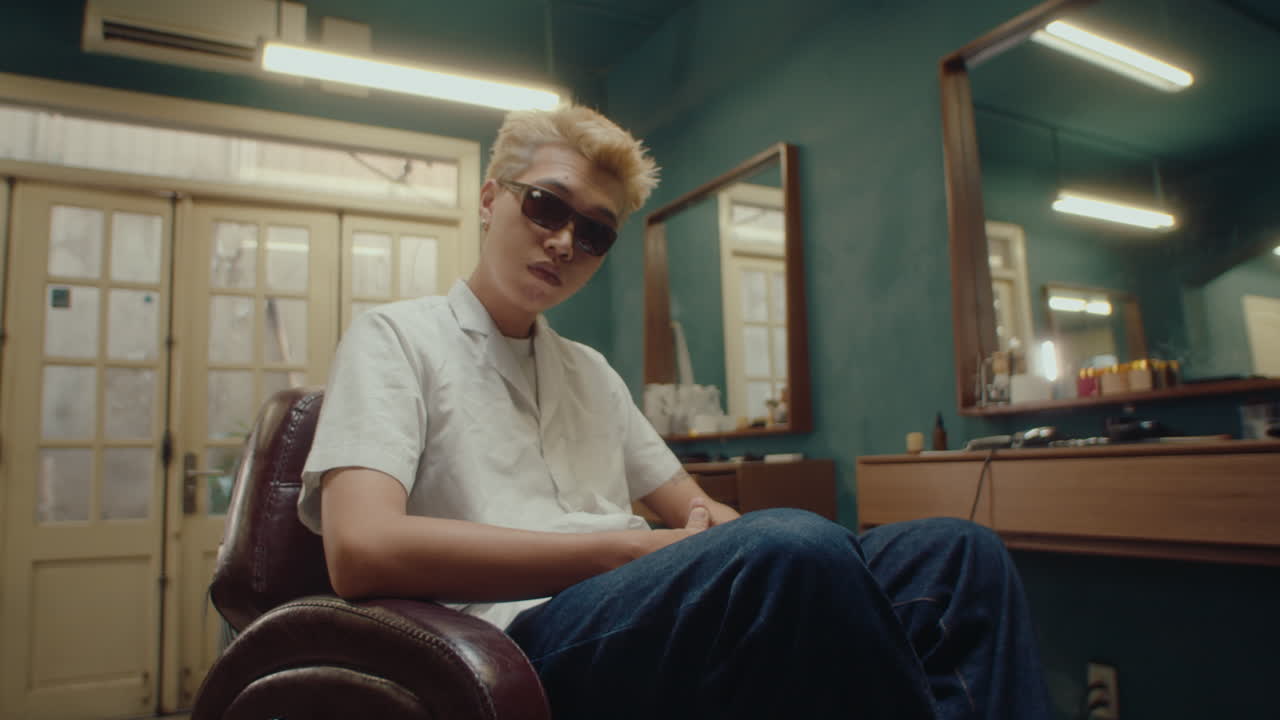 Stylish Asian Guy Posing for Camera in Barbershop