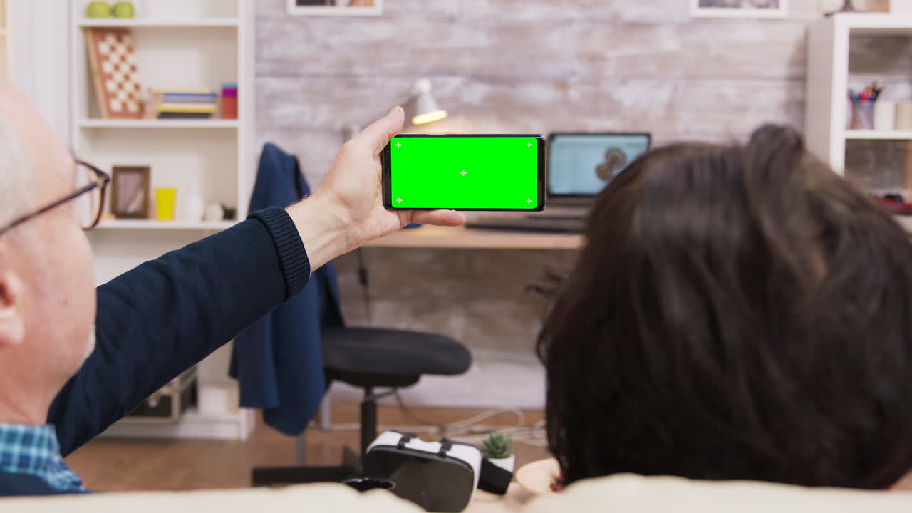 Senior Couple Making a Video Call on Smartphone with Green Screen