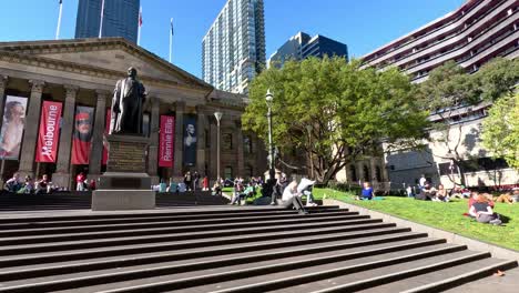 people enjoying a sunny day outside library