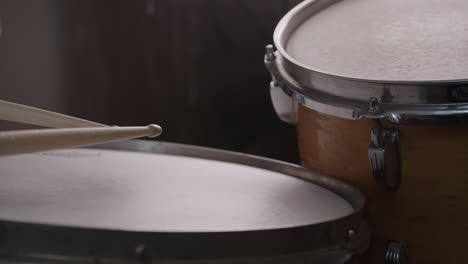 jazz drummer hits snare drum in slow motion, low angle close-up