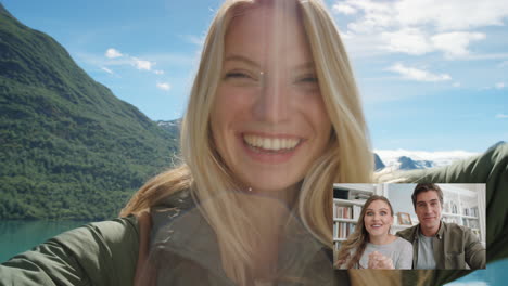 Mujer-Viajera-Feliz-Chateando-Por-Video-Con-Amigos-Lanzando-Besos-Compartiendo-Vacaciones-En-Noruega-Divirtiéndose-Mostrando-El-Lago-Y-La-Naturaleza