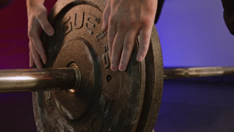 man with bulging muscles in gym preparing for strength training