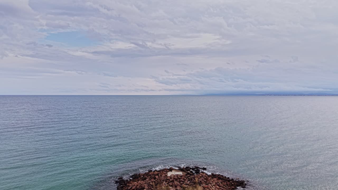 Aerial view of a rocky pathway leading into the calm waters of Bulgaria