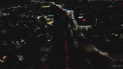 an aerial view of a long island railroad train leaving the station at night