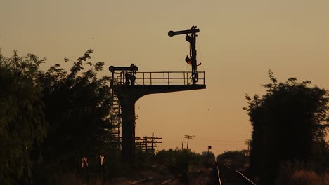 silhouette train yard at golden hour