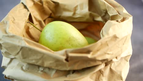 green apples in a paper bag