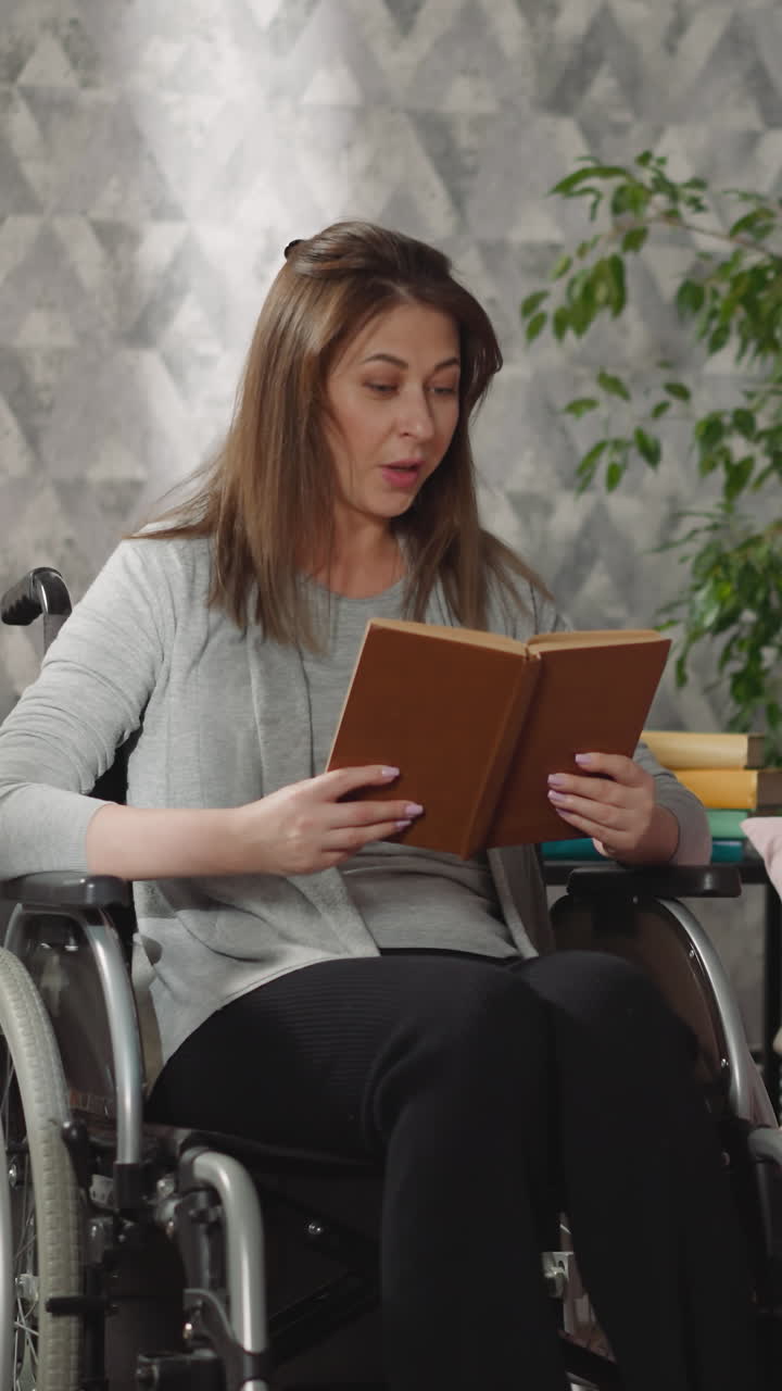 Mother reads interesting story to little daughter and son. Woman sits in wheelchair after surgery holding book. Kids rest on couch listening to mom