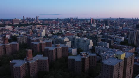 slight aerial pan down over housing projects from skyline over harlem in new york city in early morning, in 4k