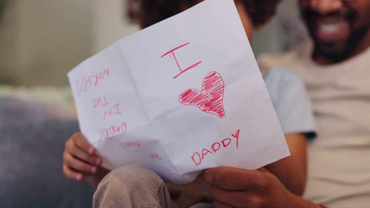 Child Giving Handmade Card to Father