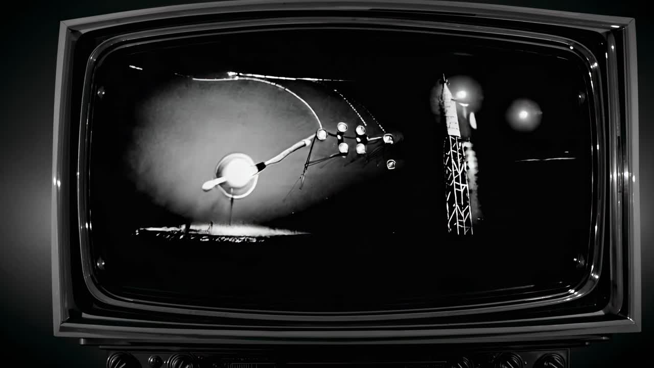 Retro TV displays a black-and-white space-themed video. Shot from a front angle, it evokes vintage