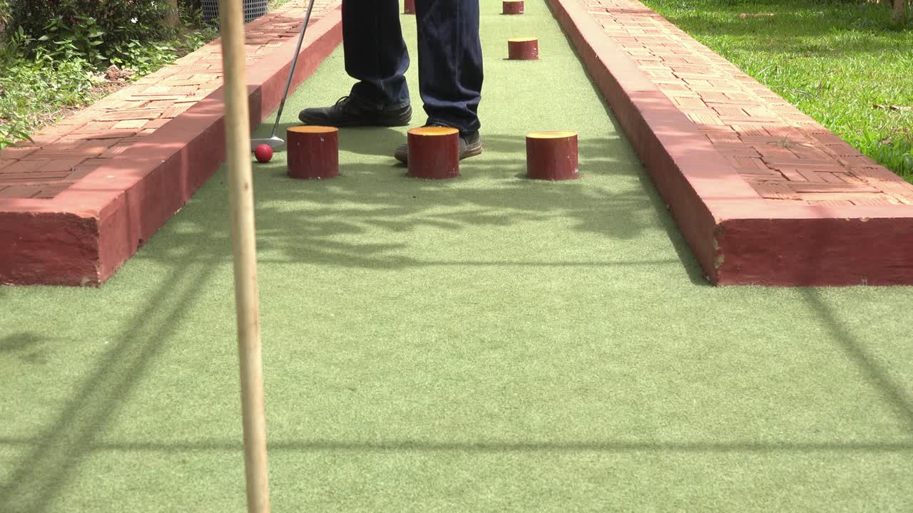Playing Mini Golf in the Sunshine and Approaching the Hole