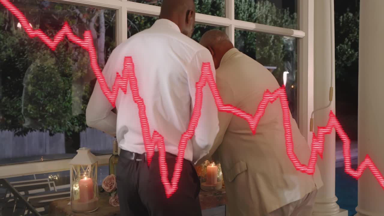 Standing man leaning in, guiding seated man rising, fixing candles, red waveform overlaying dinner