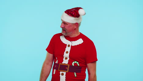 Crazy-man-in-Santa-Christmas-t-shirt-hat-demonstrating-tongue-out,-fooling-around-making-silly-faces