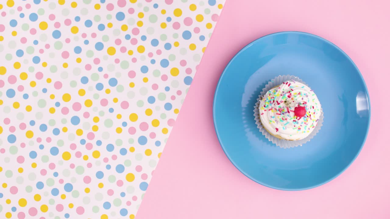 Moving cup cake on blue plate stop motion
