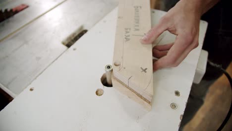 close up. the master processes wood on the machine in the woodworking workshop of a small furniture manufacturer. slow motion