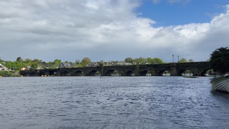 peaceful river shannon flows under irish medieval stone arch bridge