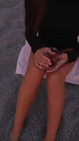 woman relaxing with tea on the beach