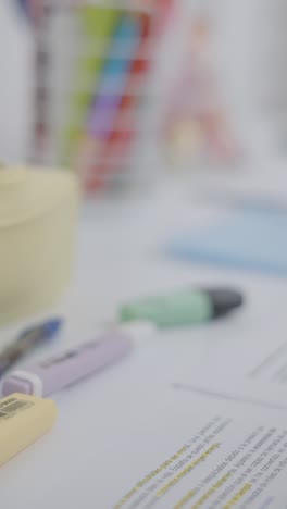 desk with highlighters and papers