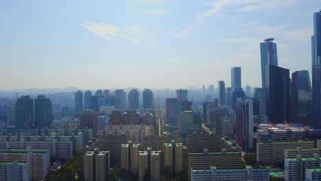 Drone-shot-traveling-forward-above-the-Han-river-toward-a-residential-district-and-business-district-in-Seoul-city-during-a-sunny-day