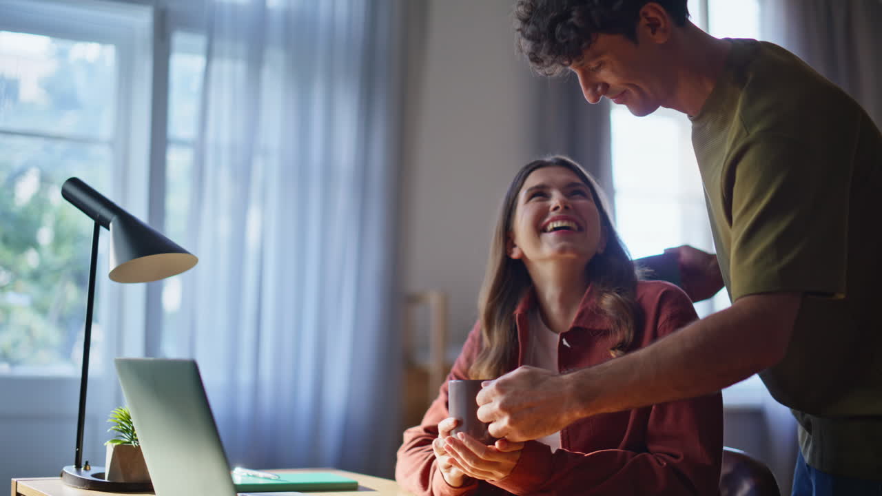 Girl video calling laptop at cozy living room. Happy woman waving hand at home