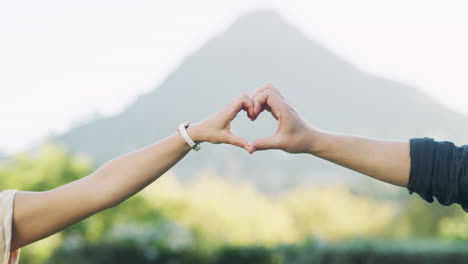 couple making heart shape with hands