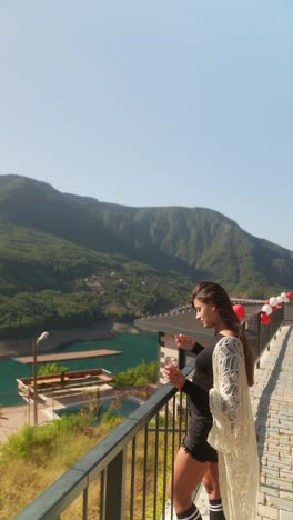 woman enjoying scenic view of the mountains and lake