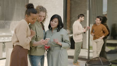 a beautiful  group of three girls looking something at the phone 1