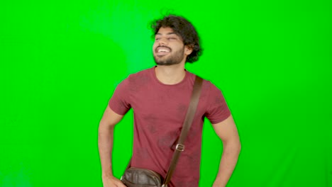 Indian-guy-wink-to-people-and-public-with-green-screen-and-green-background