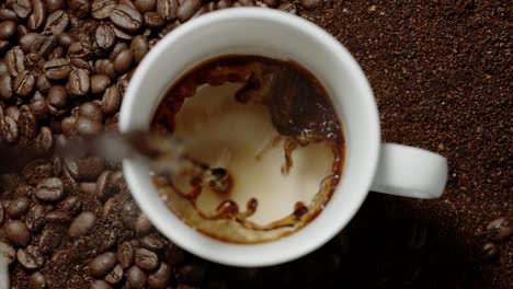 coffee is poured into a mug