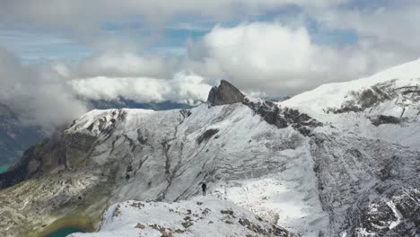 Drone-shot-moving-backwards,-revealing-a-gorgeous-landscape-in-the-wild-outdoors-of-Switzerland