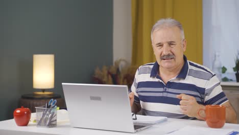home office worker old man looking nervously at camera.