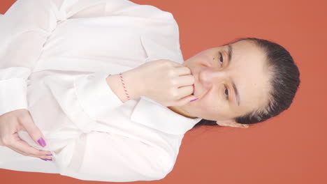 Vertical-video-of-The-woman-is-biting-her-nails.