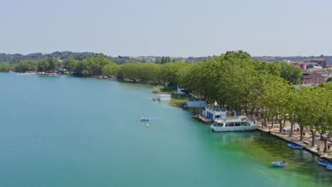 slow aerial flyby over rowboats and pleasure craft on the shores of lake banyoles