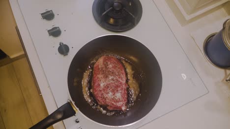 frying a4 wagyu beef steak on sizzling oil in a frying pan