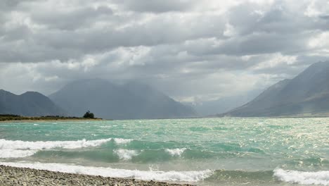 sunny lake ohau, new zealand underneath heavy storm clouds