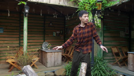 Man-dancing-asian-freestyle-with-curious-dance-steps-in-exterior-garden