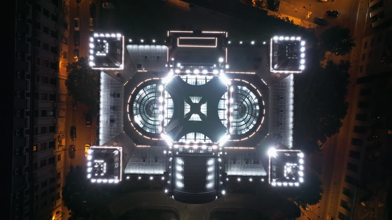 Aerial drone view of the Palace of the Deposits and Consignments illuminated in Bucharest, Romania at night