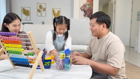 a family enjoys quality time playing with colorful educational toys in a bright, cozy living room setting