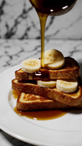 delicious stacked french toast with bananas and maple syrup
