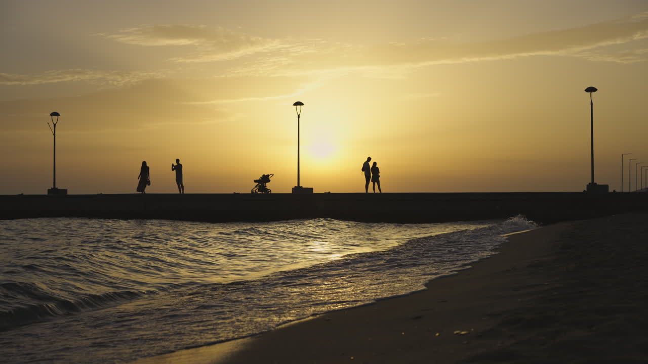 Silhouettes on a beach at sunset