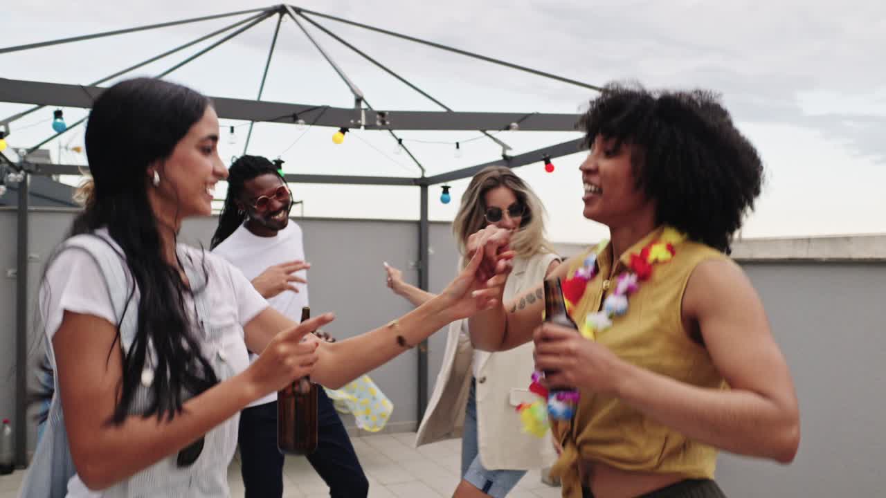 Group of friends having fun at a rooftop party