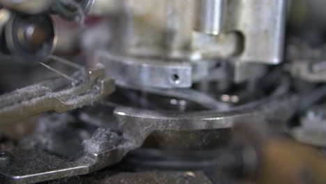 close-up parts of the machine with threads, the production process in a garment factory, automated process, manufacture of socks