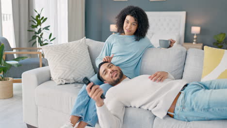 black couple watching tv in home