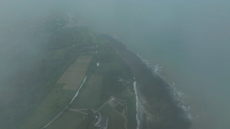 fog and clouds over strait of dover and white cliffs in kent, england, uk. - aerial shot