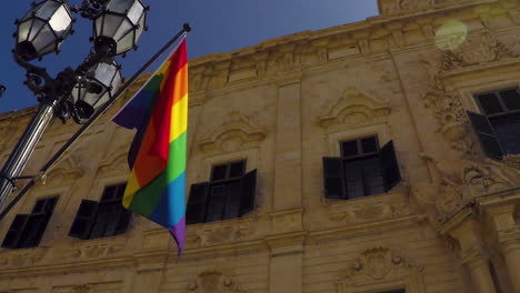 lgbt flag waving in front of administrative building