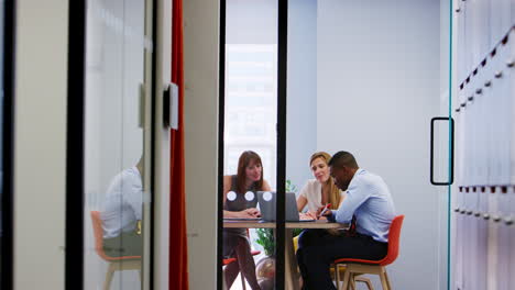 Three-business-colleagues-at-an-informal-office-meeting