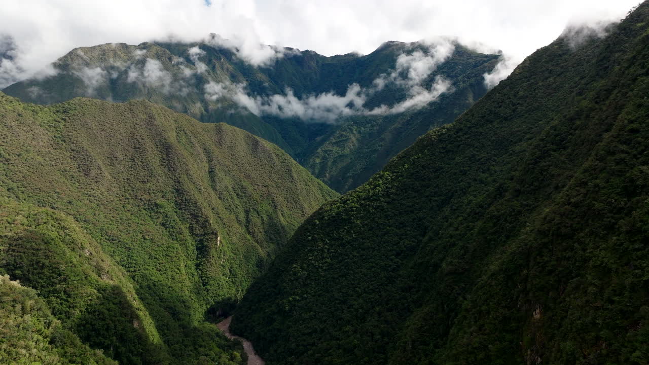 Urubamba River flowing through lush green valley in Andes Mountains, Peru. Aerial drone